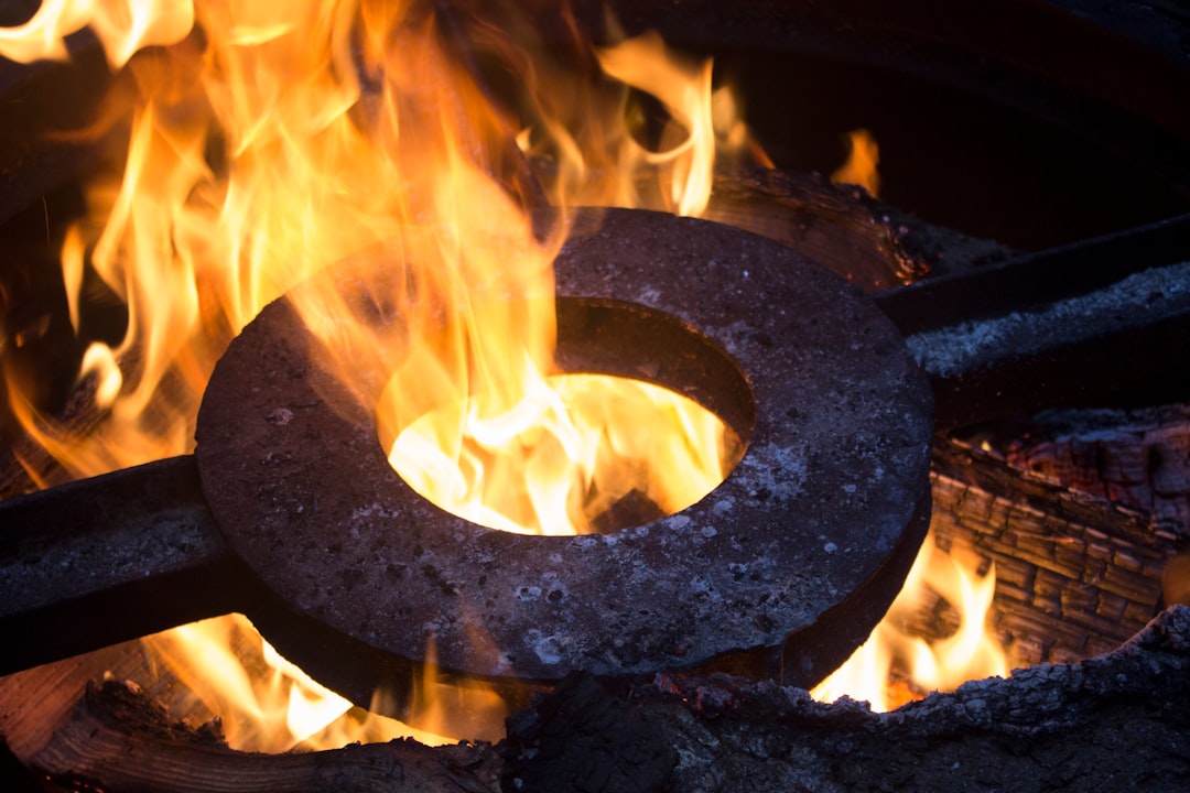 a-metal-ring-sitting-on-top-of-a-fire-otcfezyyqqw